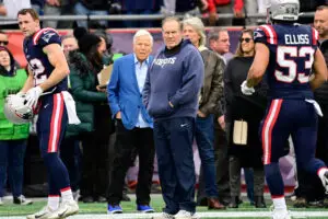 Dec 17, 2023; Foxborough, Massachusetts, USA; New England Patriots head coach Bill Belichick watches the team warm up before a game against the Kansas City Chiefs as owner Robert Kraft stands behind him at Gillette Stadium. Mandatory Credit: Eric Canha-USA TODAY Sports