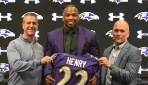 Baltimore ravens Newly signed Ravens running back Derrick Henry stands with coach John Harbaugh, left, and general manager Eric DeCosta at a news conference Thursday in Owings Mills. (Kevin Richardson/Staff)