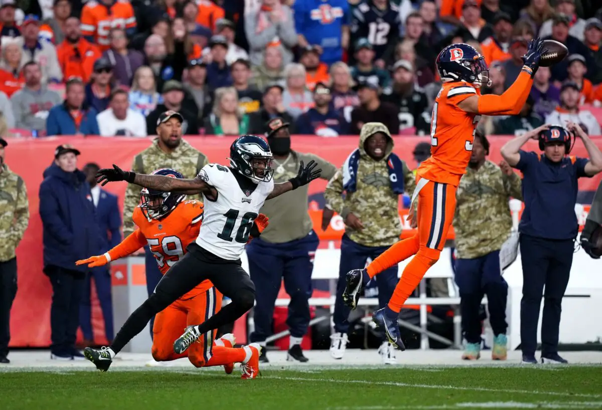 Nov 14, 2021; Denver, Colorado, USA; Denver Broncos free safety Justin Simmons (31) intercepts a football intended for Philadelphia Eagles wide receiver Quez Watkins (16) in the third quarter at Empower Field at Mile High. Mandatory Credit: Ron Chenoy-USA TODAY Sports