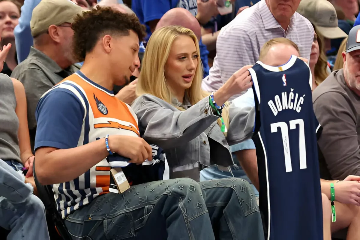 Kansas City Chiefs quarterback Patrick Mahomes and his wife Brittany look at a Luka Doncic jersey they were given during the game between the Toronto Raptors and the Dallas Mavericks at American Airlines Center on November 08, 2023 in Dallas, Texas. (Photo by Richard Rodriguez/Getty Images)