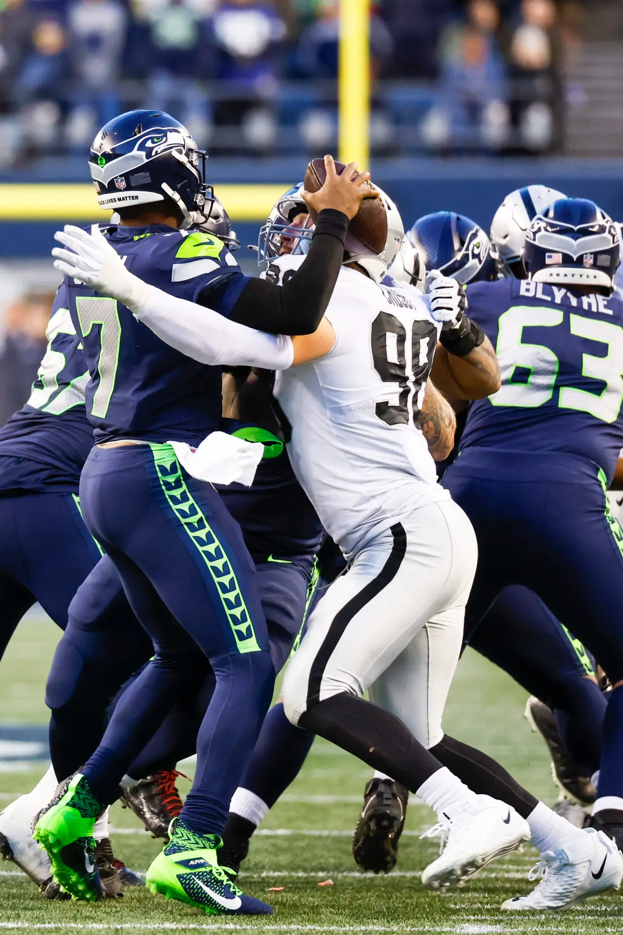 Nov 27, 2022; Seattle, Washington, USA; Las Vegas Raiders defensive end Maxx Crosby (98) sacks Seattle Seahawks quarterback Geno Smith (7) during the fourth quarter at Lumen Field. Mandatory Credit: Joe Nicholson-USA TODAY Sports