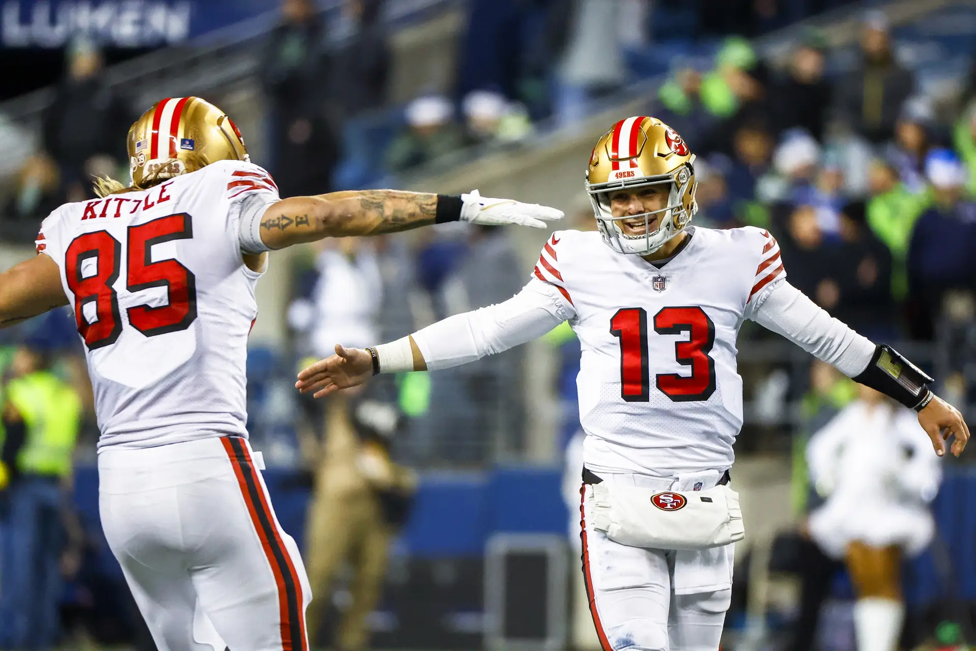 Dec 15, 2022; Seattle, Washington, USA; San Francisco 49ers quarterback Brock Purdy (13) celebrates with tight end George Kittle (85) during the late fourth quarter against the Seattle Seahawks at Lumen Field. Mandatory Credit: Joe Nicholson-USA TODAY Sports
