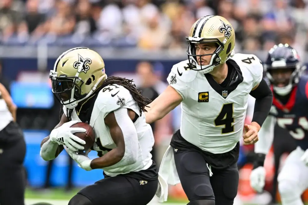 Oct 15, 2023; Houston, Texas, USA; New Orleans Saints quarterback Derek Carr (4) hands off the ball to running back Alvin Kamara (41) during the first quarter against the Houston Texans at NRG Stadium. Mandatory Credit: Maria Lysaker-USA TODAY Sports