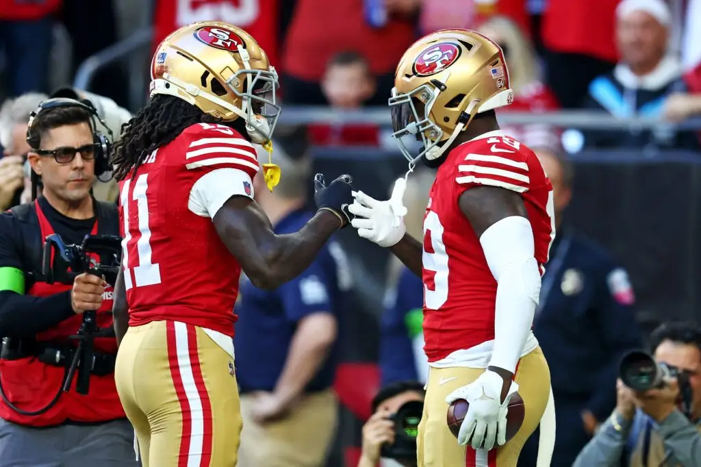 Dec 17, 2023; Glendale, Arizona, USA; San Francisco 49ers wide receiver Deebo Samuel (19) celebrates with wide receiver Brandon Aiyuk (11) after scoring a touchdown during the first quarter against the Arizona Cardinals at State Farm Stadium. Mandatory Credit: Mark J. Rebilas-USA TODAY Sports