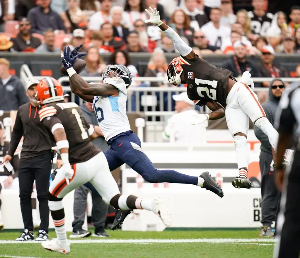 Cleveland Browns cornerback Denzel Ward (21) and safety Juan Thornhill (1) break up a pass intended for Tennessee Titans wide receiver Treylon Burks (16) during the fourth quarter in Cleveland, Ohio, Sunday, Sept. 24, 2023.