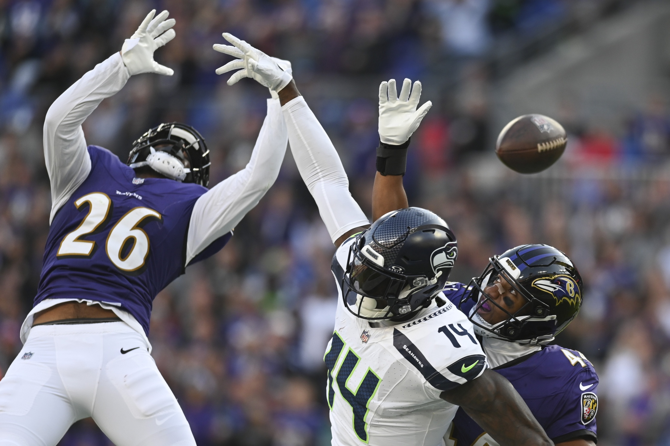 Nov 5, 2023; Baltimore, Maryland, USA; Baltimore Ravens safety Geno Stone (26) and cornerback Marlon Humphrey (44) break up a pass intended for Seattle Seahawks wide receiver DK Metcalf (14) in the end zone during the second half at M&T Bank Stadium. Mandatory Credit: Tommy Gilligan-USA TODAY Sports