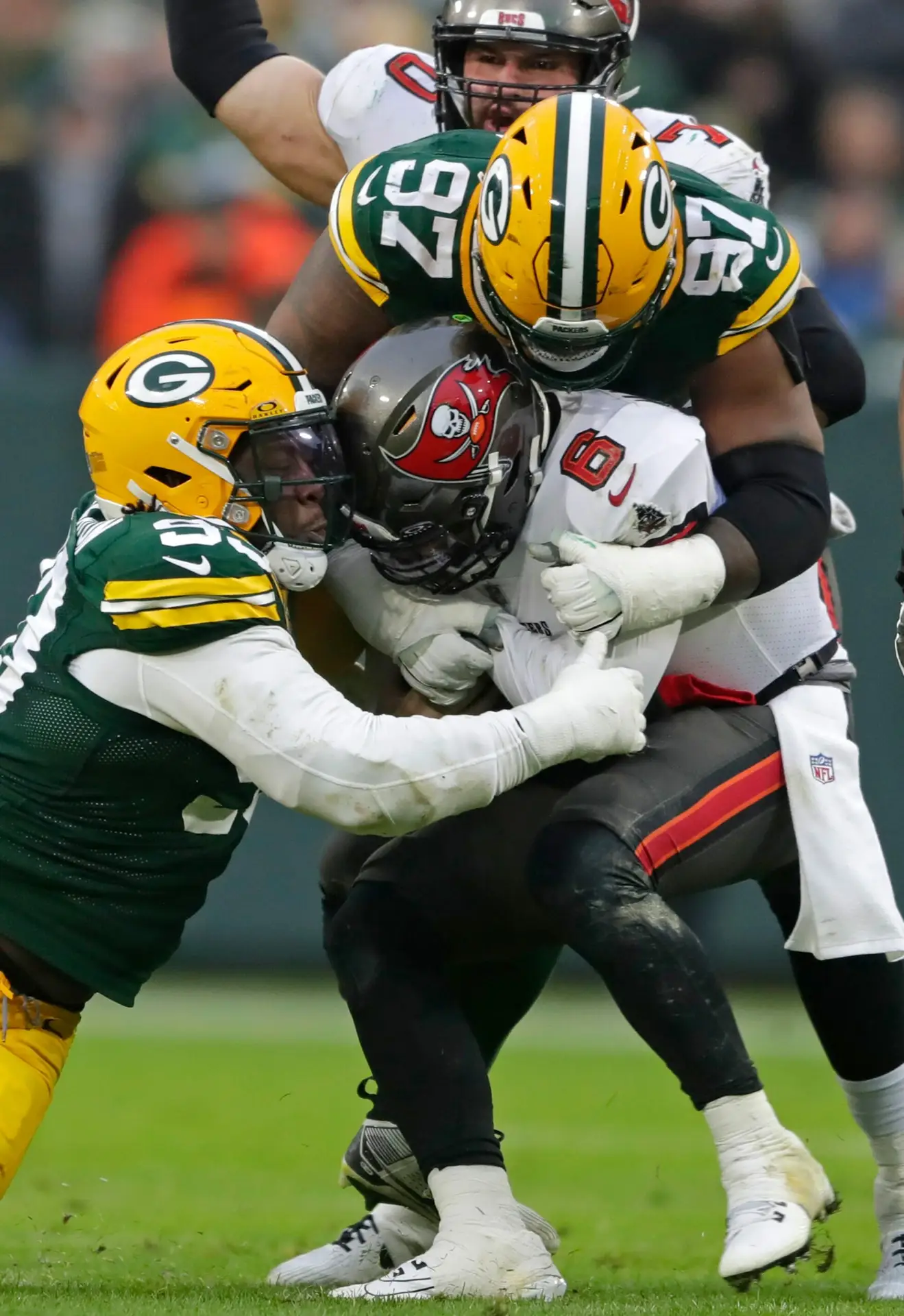 Green Bay Packers defensive tackle T.J. Slaton (93) and defensive tackle Kenny Clark (97) sack Tampa Bay Buccaneers quarterback Baker Mayfield (6) during their football game on Sunday, December 17, 2023, at Lambeau Field in Green Bay Wis. Tampa Bay defeated Green Bay 34-20.