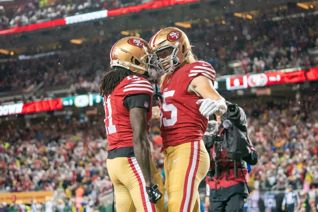 January 20, 2024; Santa Clara, CA, USA; San Francisco 49ers tight end George Kittle (85) is congratulated by wide receiver Brandon Aiyuk (11) after scoring a touchdown during the second quarter in a 2024 NFC divisional round game against the Green Bay Packers at Levi's Stadium. Mandatory Credit: Kyle Terada-USA TODAY Sports