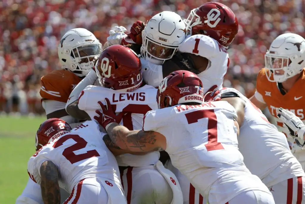 Oklahoma Sooners defensive back Billy Bowman Jr. (2), Oklahoma Sooners linebacker Kip Lewis (10), Oklahoma Sooners linebacker Jaren Kanak (7) and Oklahoma Sooners linebacker Dasan McCullough (1) stop Texas Longhorns running back Jonathon Brooks (24) during the Red River Rivalry college football game between the University of Oklahoma Sooners (OU) and the University of Texas (UT) Longhorns at the Cotton Bowl in Dallas, Saturday, Oct. 7, 2023. Oklahoma won 34-30.