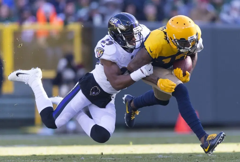 Nov 19, 2017; Green Bay, WI, USA; Green Bay Packers wide receiver Davante Adams (17) is tackled by Baltimore Ravens cornerback Marlon Humphrey (29) after catching a pass during the second quarter at Lambeau Field. Mandatory Credit: Jeff Hanisch-USA TODAY Sports