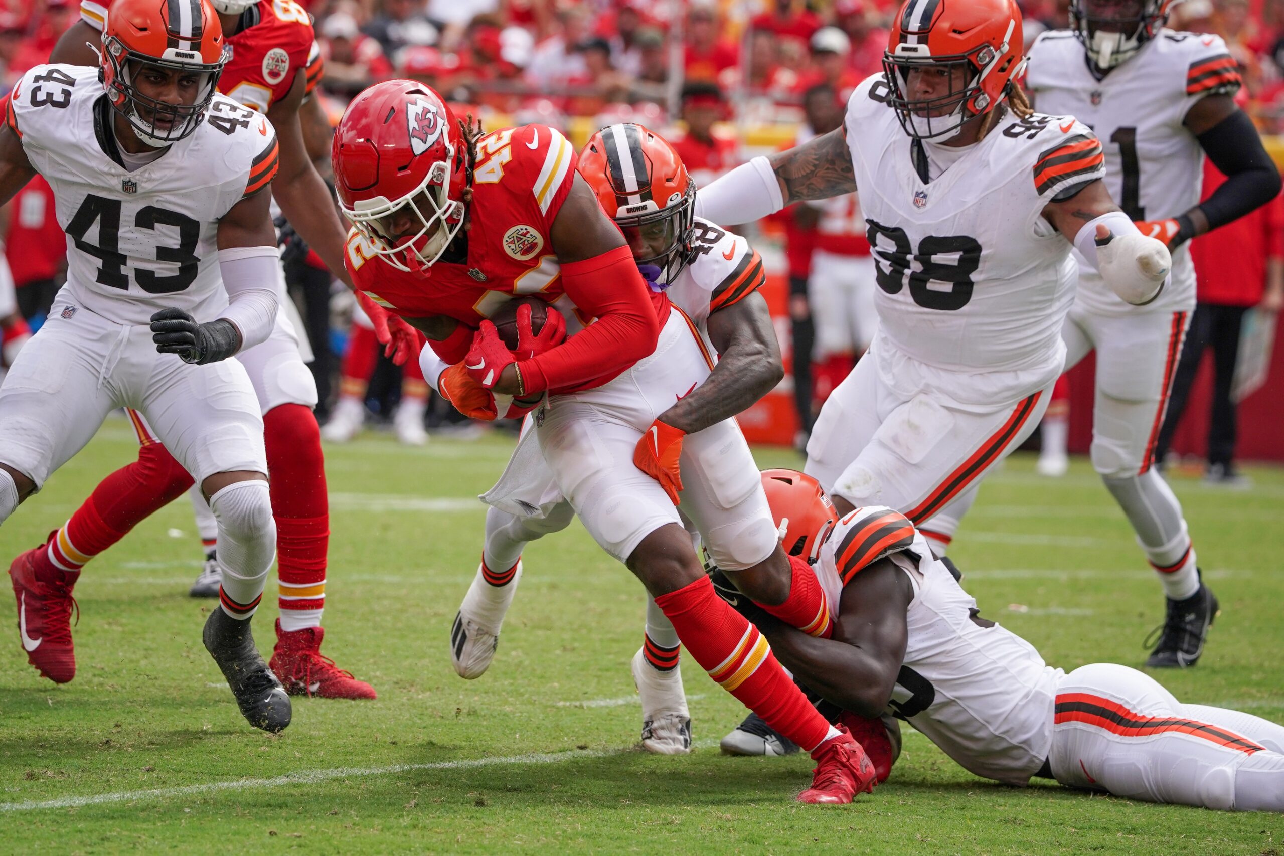 Aug 26, 2023; Kansas City, Missouri, USA; Kansas City Chiefs tight end Izaiah Gathings (42) is tackled by Cleveland Browns safety Tanner McCalister (48) during the second half at GEHA Field at Arrowhead Stadium. Mandatory Credit: Denny Medley-USA TODAY Sports