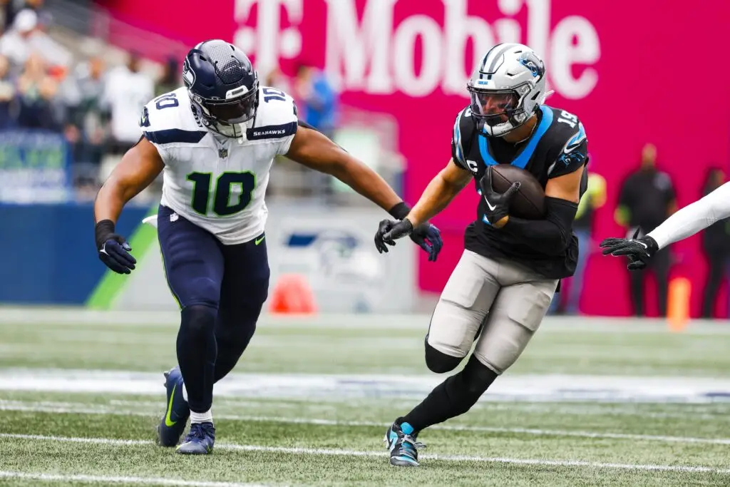 Sep 24, 2023; Seattle, Washington, USA; Carolina Panthers wide receiver Adam Thielen (19) runs for yards after the catch against Seattle Seahawks linebacker Uchenna Nwosu (10) during the first quarter at Lumen Field. Mandatory Credit: Joe Nicholson-USA TODAY Sports