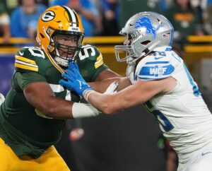 Sep 28, 2023; Green Bay, Wisconsin, USA; Green Bay Packers guard Zach Tom (50) moves in against Detroit Lions linebacker Jack Campbell (46) during the first quarter at Lambeau Field. Mandatory Credit: Mark Hoffman-USA TODAY Sports