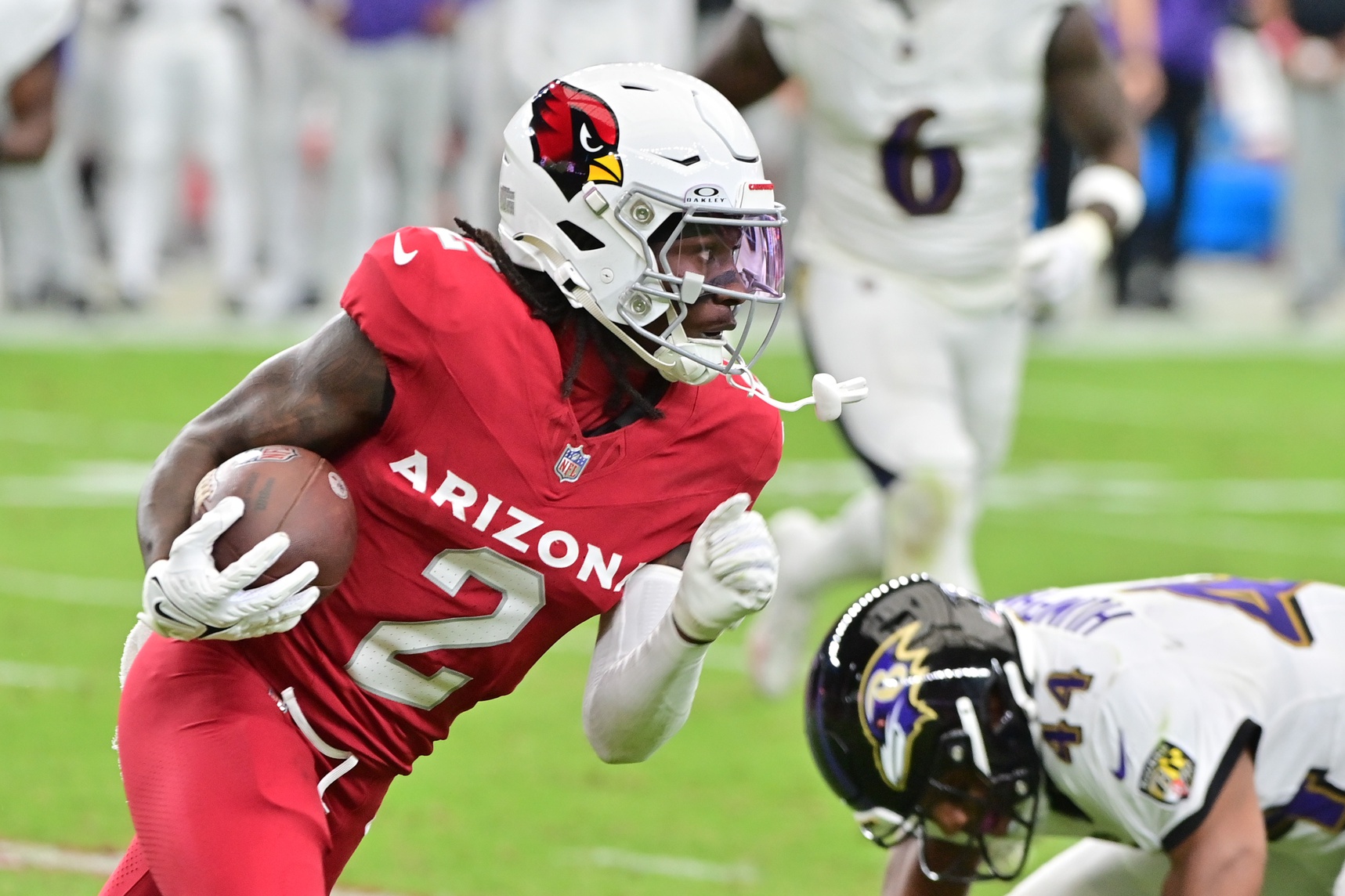 Oct 29, 2023; Glendale, Arizona, USA; Arizona Cardinals wide receiver Marquise Brown (2) runs with the ball as Baltimore Ravens cornerback Marlon Humphrey (44) defends in the first half at State Farm Stadium. Mandatory Credit: Matt Kartozian-USA TODAY Sports