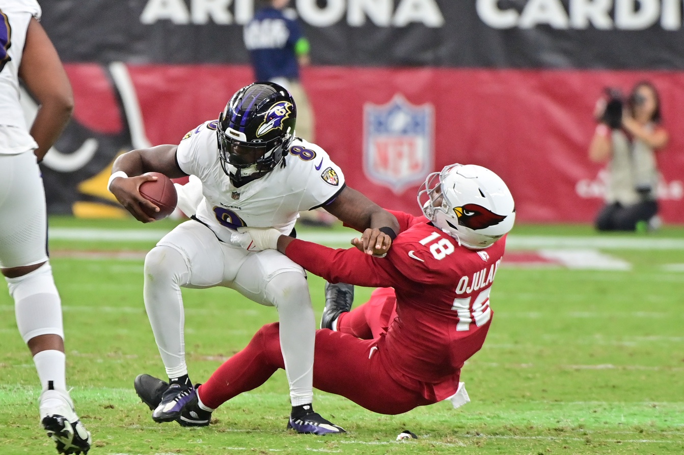 Oct 29, 2023; Glendale, Arizona, USA; Arizona Cardinals linebacker BJ Ojulari (18) sacks Baltimore Ravens quarterback Lamar Jackson (8) in the second half at State Farm Stadium. Mandatory Credit: Matt Kartozian-USA TODAY Sports