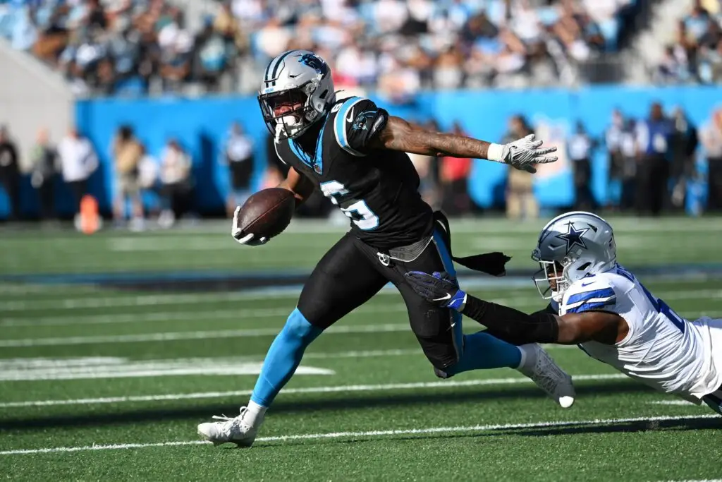 Nov 19, 2023; Charlotte, North Carolina, USA; Carolina Panthers running back Miles Sanders (6) with the ball as Dallas Cowboys safety Donovan Wilson (6) defends in the second quarter at Bank of America Stadium. Mandatory Credit: Bob Donnan-USA TODAY Sports