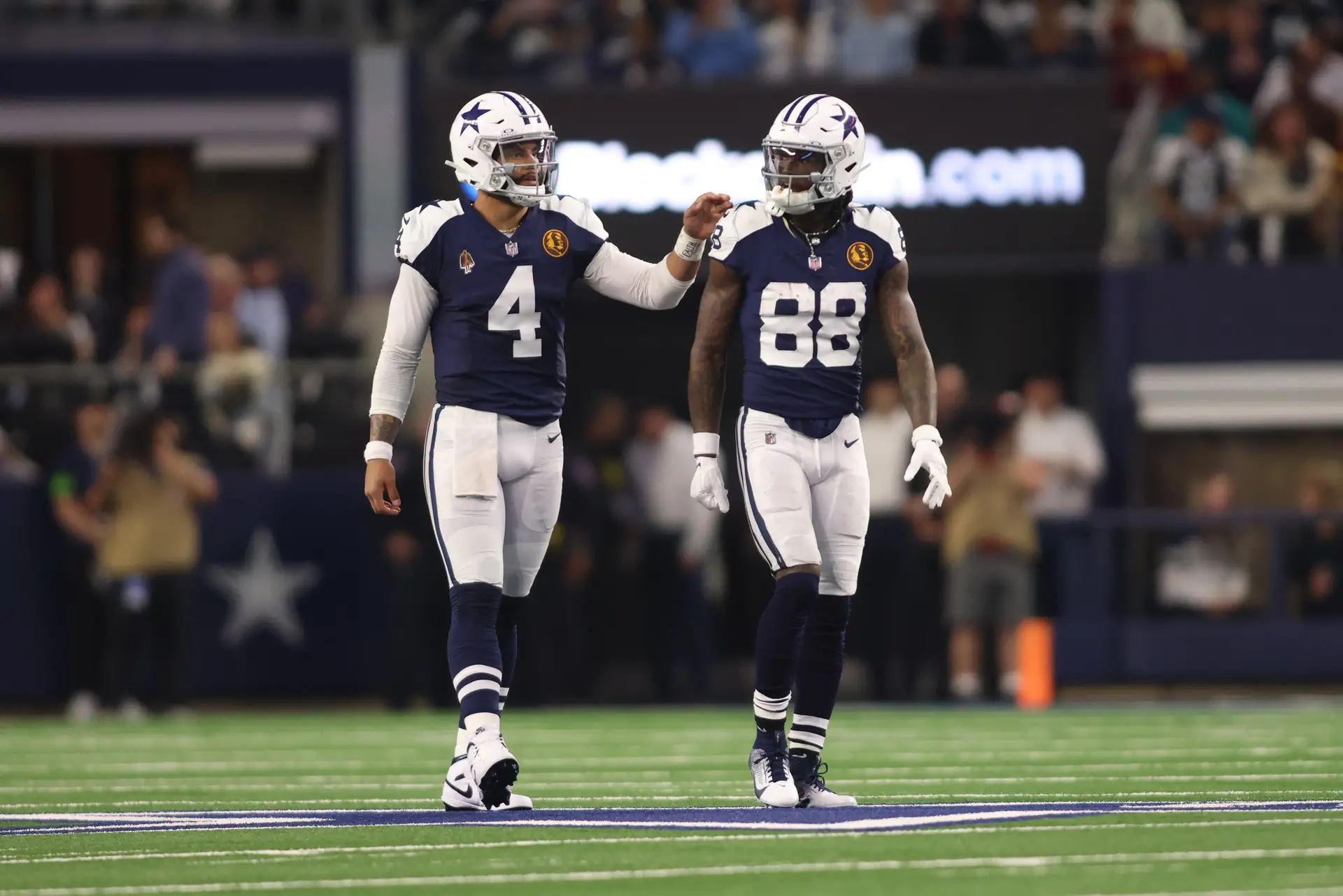 Nov 23, 2023; Arlington, Texas, USA; Dallas Cowboys wide receiver CeeDee Lamb (88) and quarterback Dak Prescott (4) talk during the game against the Washington Commanders at AT&T Stadium. Mandatory Credit: Tim Heitman-USA TODAY Sports