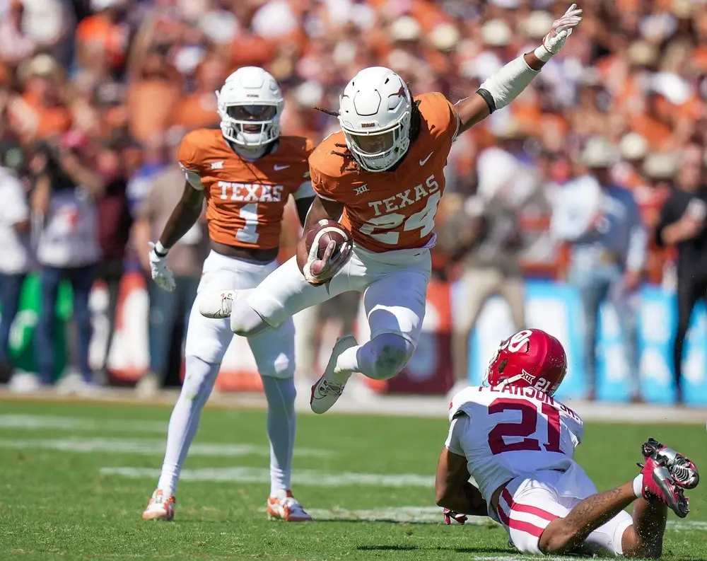 Texas Longhorns running back Jonathon Brooks (24) jumps over Oklahoma Sooners defensive back Reggie Pearson (21) for the first down in the third quarter during an NCAA college football game at the Cotton Bowl on Saturday, Oct. 7, 2023 in Dallas, Texas. This game makes up the119th rivalry match up. © Ricardo Brazziell / USA TODAY NETWORK. (Carolina Panthers)