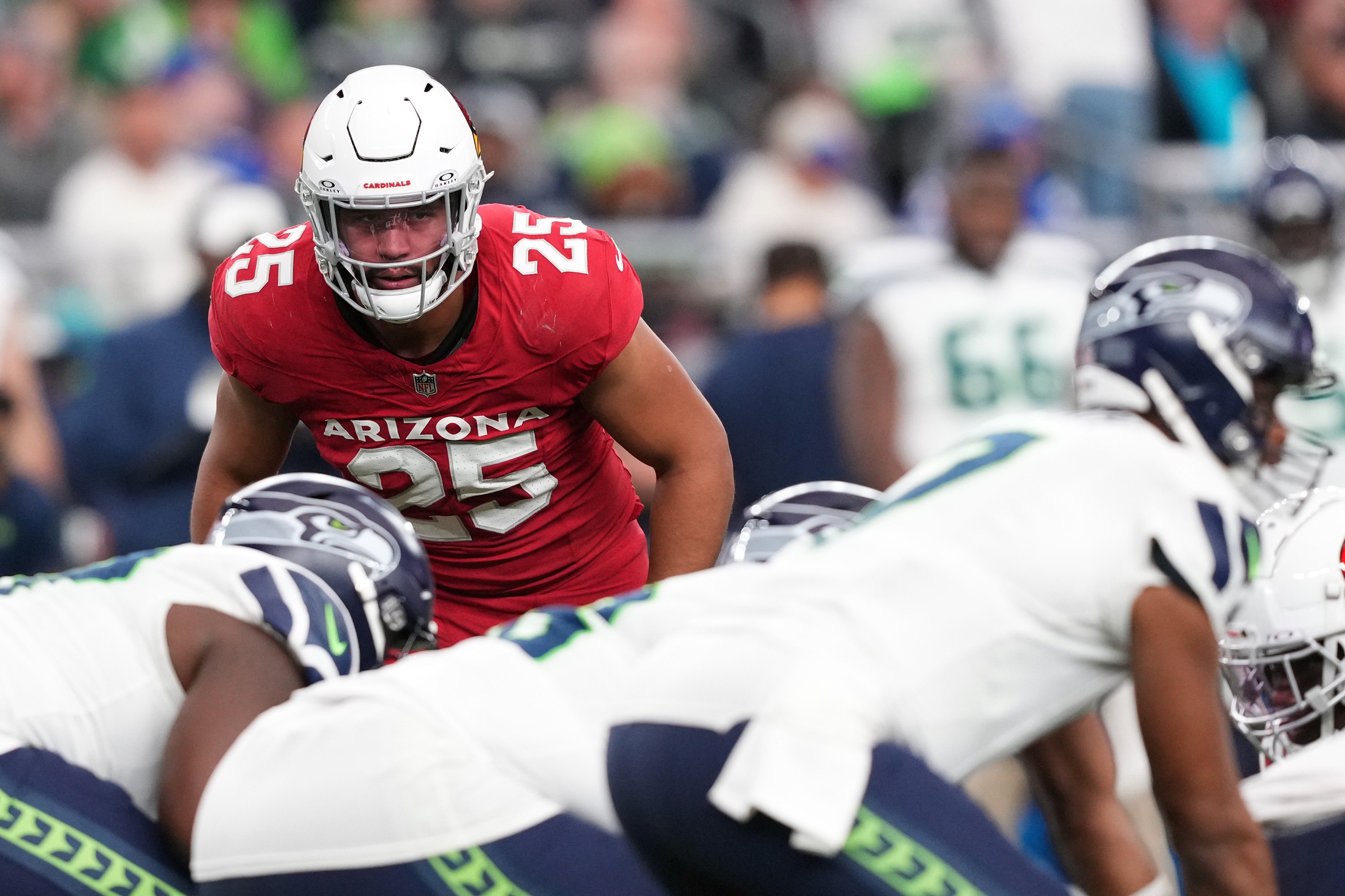 Jan 7, 2024; Glendale, Arizona, USA; Arizona Cardinals linebacker Zaven Collins (25) looks down Seattle Seahawks quarterback Geno Smith (7) during the second half at State Farm Stadium. Mandatory Credit: Joe Camporeale-USA TODAY Sports