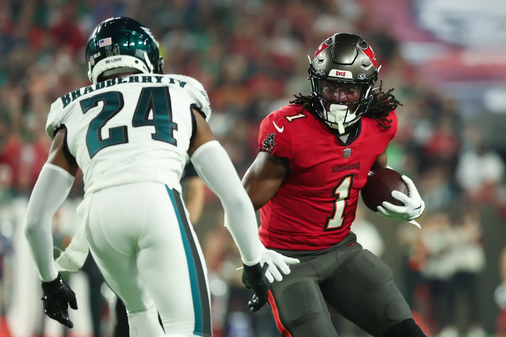 Jan 15, 2024; Tampa, Florida, USA; Tampa Bay Buccaneers running back Rachaad White (1) runs the ball as Philadelphia Eagles cornerback James Bradberry (24) defends during the first half of a 2024 NFC wild card game at Raymond James Stadium. Mandatory Credit: Kim Klement Neitzel-USA TODAY Sports