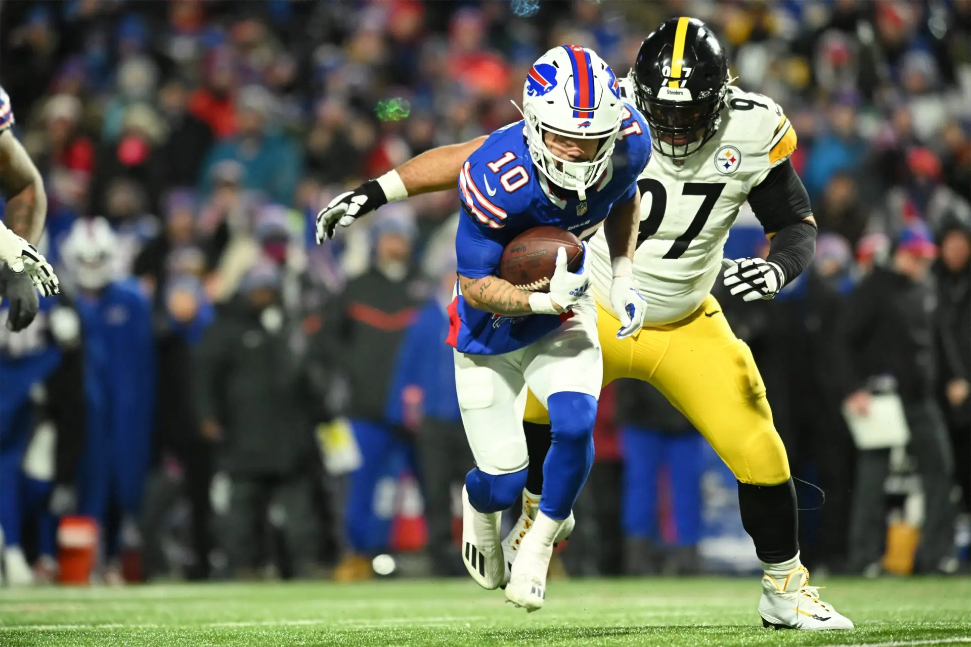 Jan 15, 2024; Orchard Park, New York, USA; Buffalo Bills wide receiver Khalil Shakir (10) runs the ball pressured by Pittsburgh Steelers defensive tackle Cameron Heyward (97) in the second half in a 2024 AFC wild card game at Highmark Stadium. Mandatory Credit: Mark Konezny-USA TODAY Sports