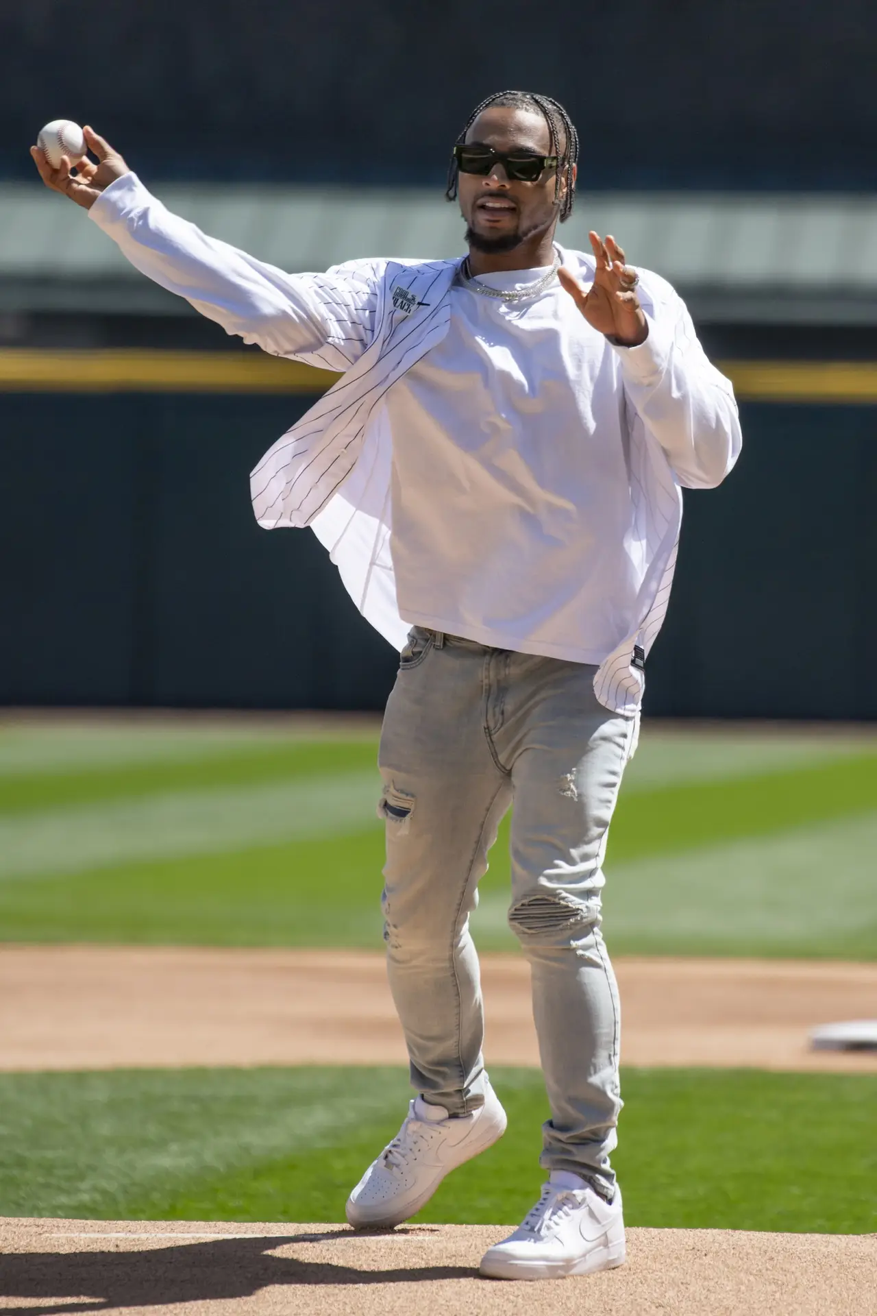 Apr 13, 2024; Chicago, Illinois, USA; Chicago Bears safety Jonathan Owens throws out the first pitch before a game between the Chicago White Sox and the Cincinnati Reds at Guaranteed Rate Field. Mandatory Credit: Patrick Gorski-USA TODAY Sports