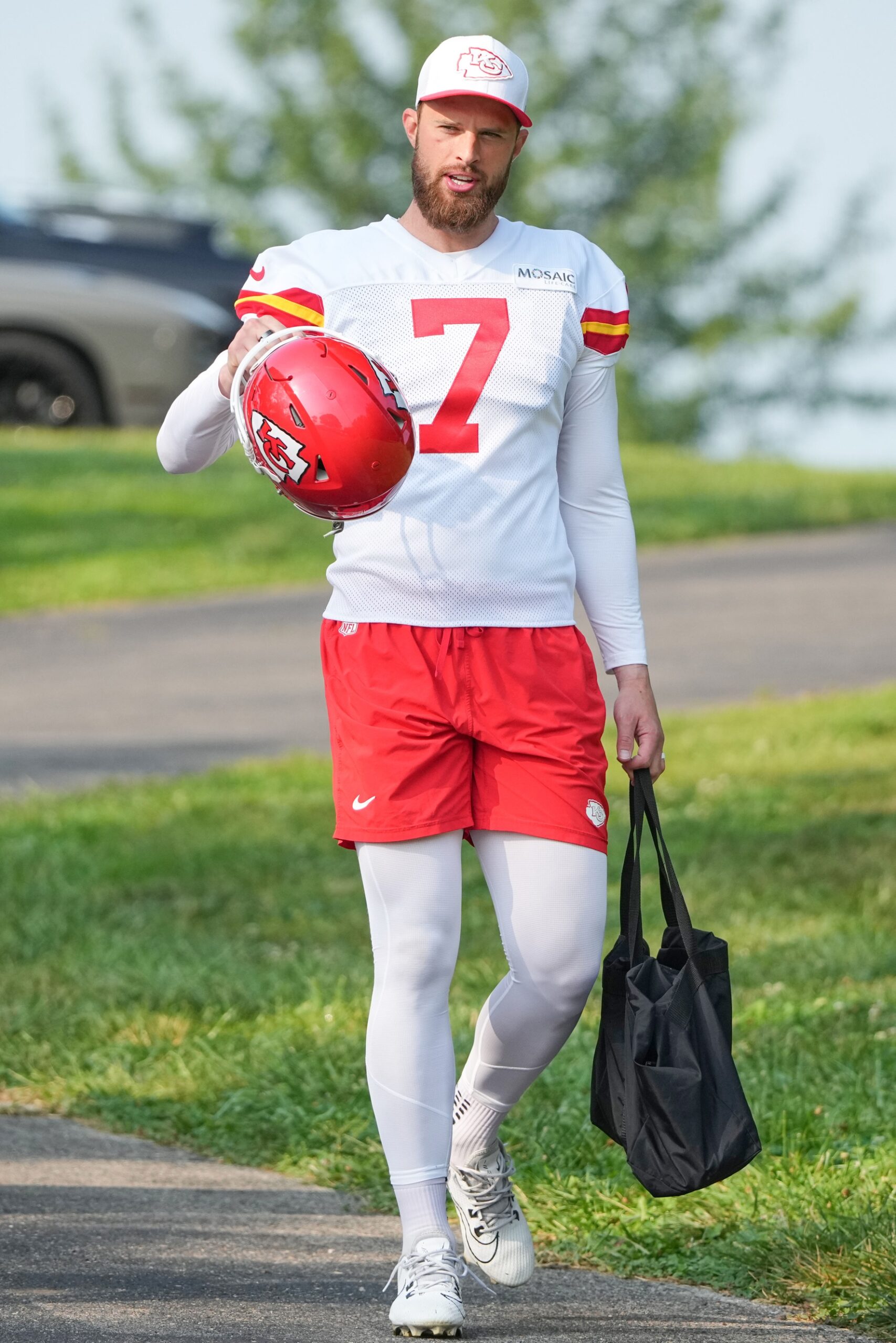 Jul 22, 2024; St. Joseph, MO, USA; Kansas City Chiefs kicker Harrison Butker (7) walks down the hill from the locker room to the fields prior to training camp at Missouri Western State University. Mandatory Credit: Denny Medley-USA TODAY Sports