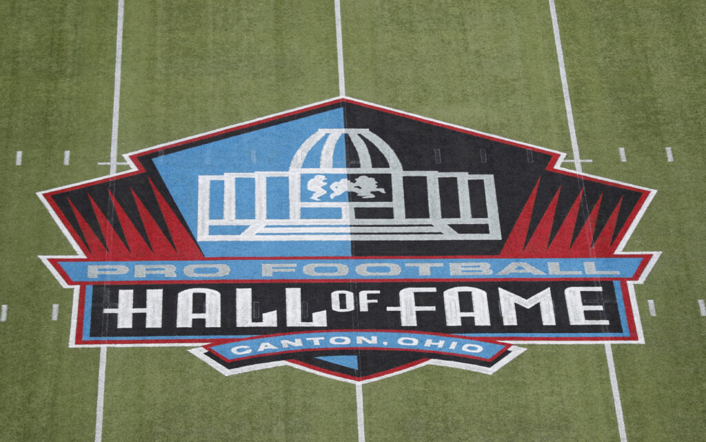 Aug 1, 2024; Canton, Ohio, USA; General view of the logo at mid-field at the Tom Benson Hall of Fame Stadium site of the Professional Football Hall of Fame game and Class of 2024 induction ceremonies. Mandatory Credit: Charles LeClaire-USA TODAY Sports