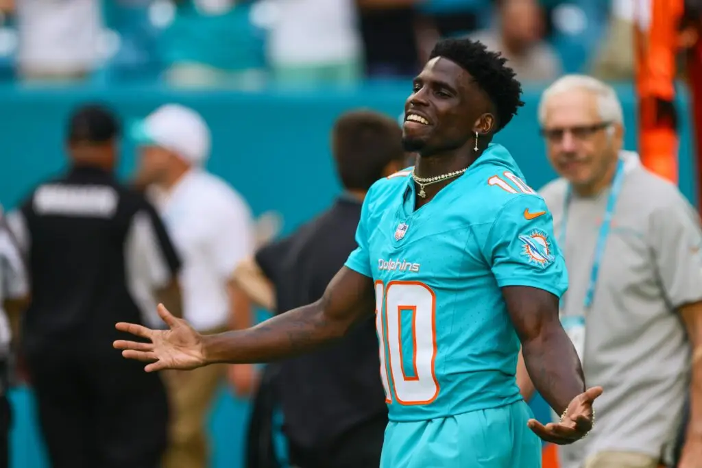 Aug 9, 2024; Miami Gardens, Florida, USA; Miami Dolphins wide receiver Tyreek Hill (10) reacts as he walks on the field before the game against the Atlanta Falcons at Hard Rock Stadium. Mandatory Credit: Sam Navarro-USA TODAY Sports