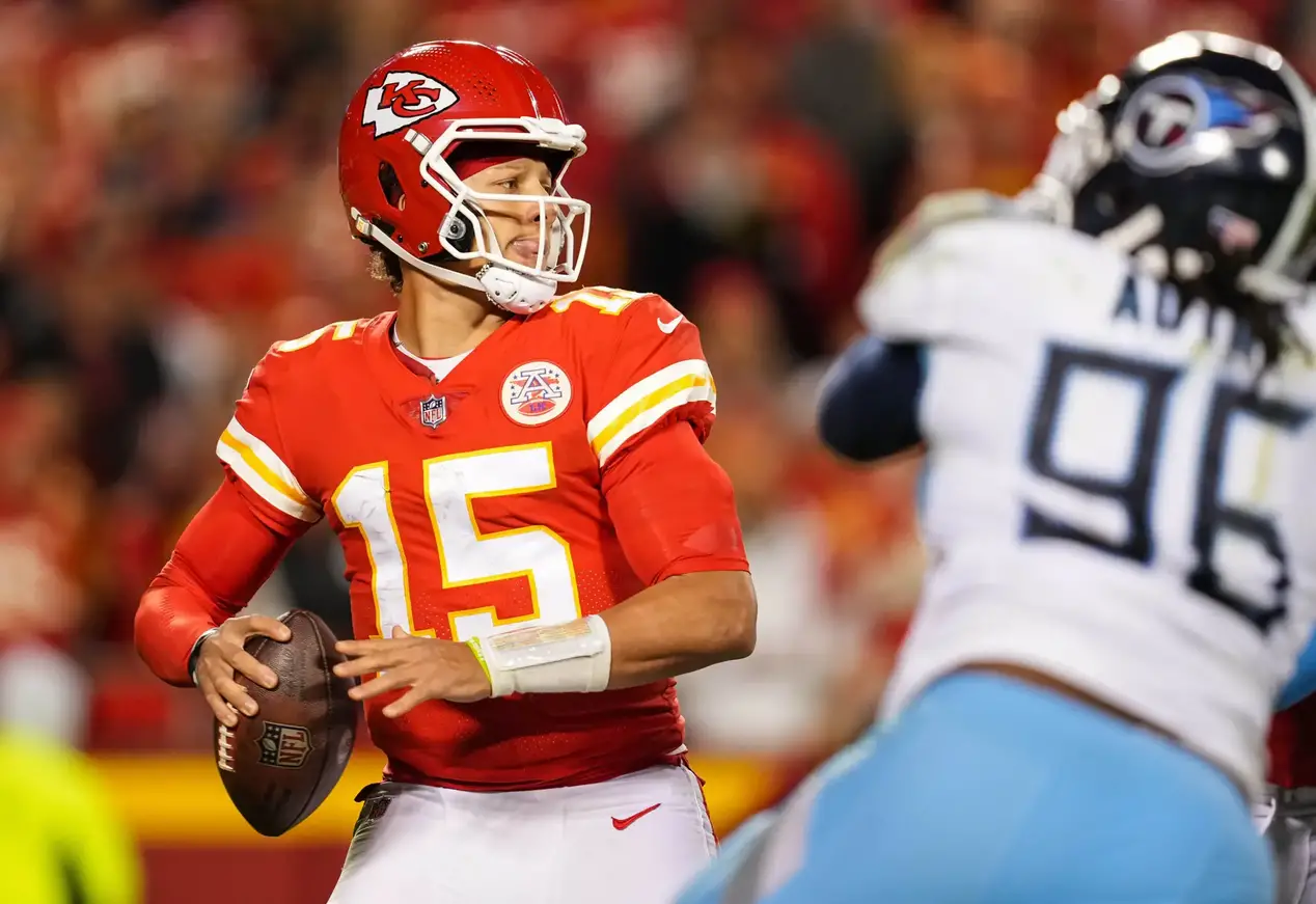 Nov 6, 2022; Kansas City, Missouri, USA; Kansas City Chiefs quarterback Patrick Mahomes (15) throws a pass as Tennessee Titans defensive end Denico Autry (96) defends during the second half against the Tennessee Titans at GEHA Field at Arrowhead Stadium. Mandatory Credit: Jay Biggerstaff-Imagn Images