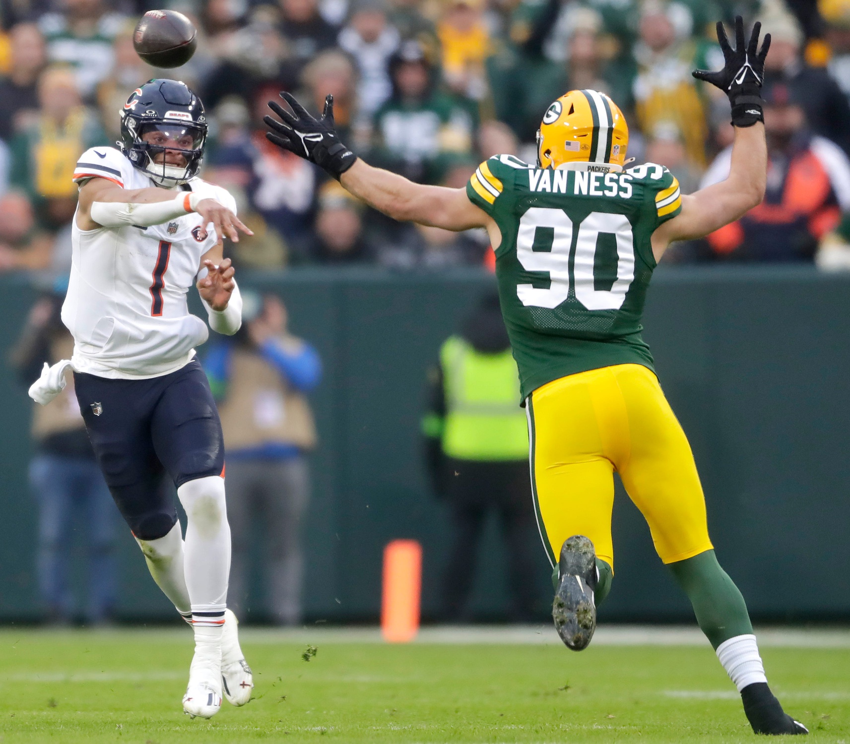 Chicago Bears quarterback Justin Fields (1) throwns under pressure from Green Bay Packers linebacker Lukas Van Ness (90) during their football game Sunday, January 7, 2024, at Lambeau Field in Green Bay, Wis. The Packers defeated the Bears 17-9. Wm. Glasheen USA TODAY NETWORK-Wisconsin