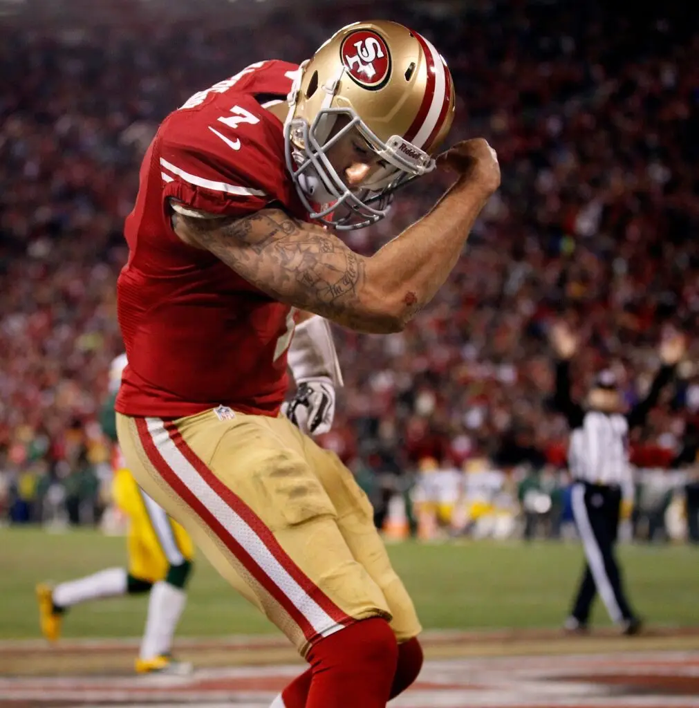 San Francisco 49ers quarterback Colin Kaepernick (7) flexes his muscles after scoring a touchdown during their 45-31 victory over Green Bay Packers in their NFC Divisional playoff game on January 11, 2013 at Candlestick Park in San Francisco, Calif. © RICK WOOD/MILWAUKEE JOURNAL SENTNEL / USA TODAY NETWORK