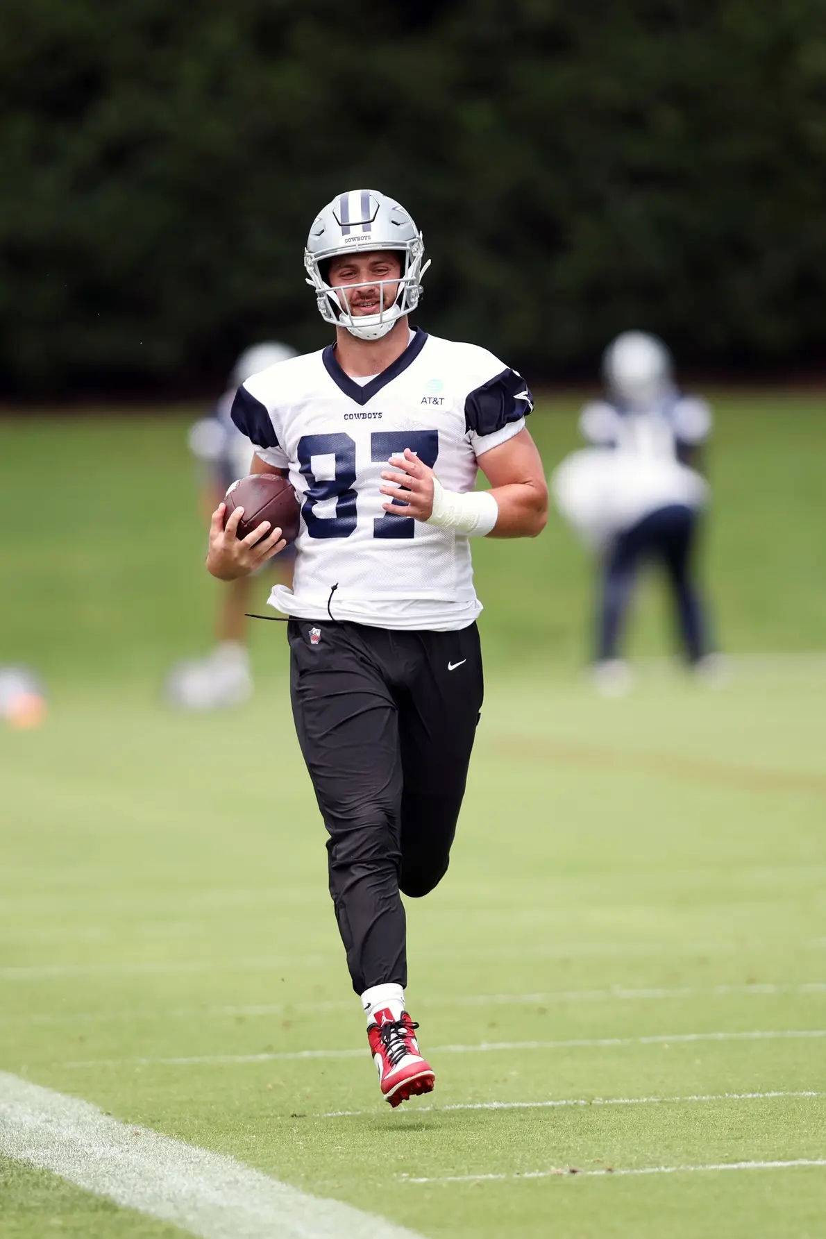 Jun 4, 2024; Frisco, TX, USA; Dallas Cowboys tight end Jake Ferguson (87) goes through a drill during practice at the Ford Center at the Star Training Facility in Frisco, Texas. Mandatory Credit: Tim Heitman-Imagn Images