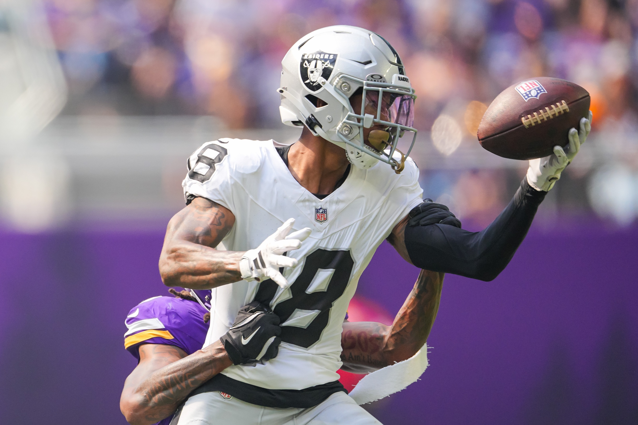 Aug 10, 2024; Minneapolis, Minnesota, USA; Las Vegas Raiders cornerback Jack Jones (18) interecpts a pass from Minnesota Vikings quarterback J.J. McCarthy (9) in the second quarter at U.S. Bank Stadium. Mandatory Credit: Brad Rempel-Imagn Images