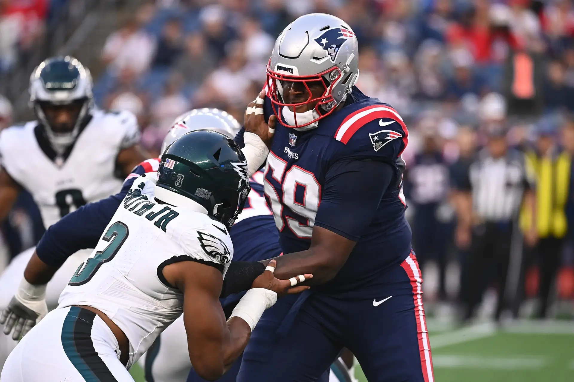 Aug 15, 2024; Foxborough, MA, USA; New England Patriots offensive tackle Vederian Lowe (59) blocks Philadelphia Eagles linebacker Nolan Smith Jr. (3) during the first half at Gillette Stadium. Mandatory Credit: Eric Canha-Imagn Images (New York Jets)