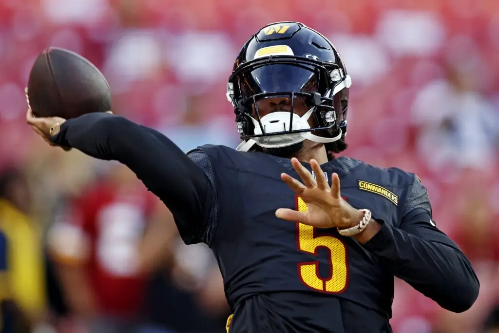 Aug 25, 2024; Landover, Maryland, USA; Washington Commanders quarterback Jayden Daniels (5) warms up before playing a preseason game against the New England Patriots at Commanders Field. Mandatory Credit: Peter Casey-Imagn Images