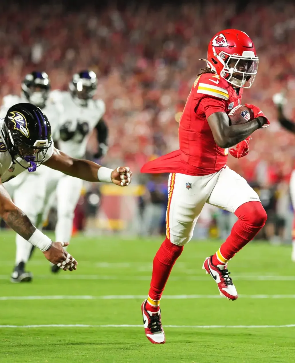 Sep 5, 2024; Kansas City, Missouri, USA; Kansas City Chiefs wide receiver Xavier Worthy (1) scores a touchdown against Baltimore Ravens linebacker Malik Harrison (40) during the first half at GEHA Field at Arrowhead Stadium. Mandatory Credit: Jay Biggerstaff-Imagn Images