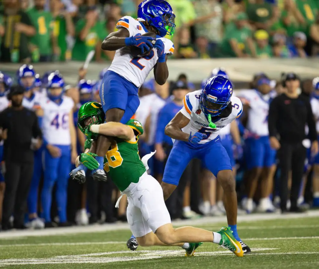 Oregon’s Bryce Boettcher, bottom, brings Boise State’s Ashton Jeanty down short of a first down during the second quarter at Autzen Stadium in Eugene Sept. 7, 2024.© Chris Pietsch/The Register-Guard / USA TODAY NETWORK