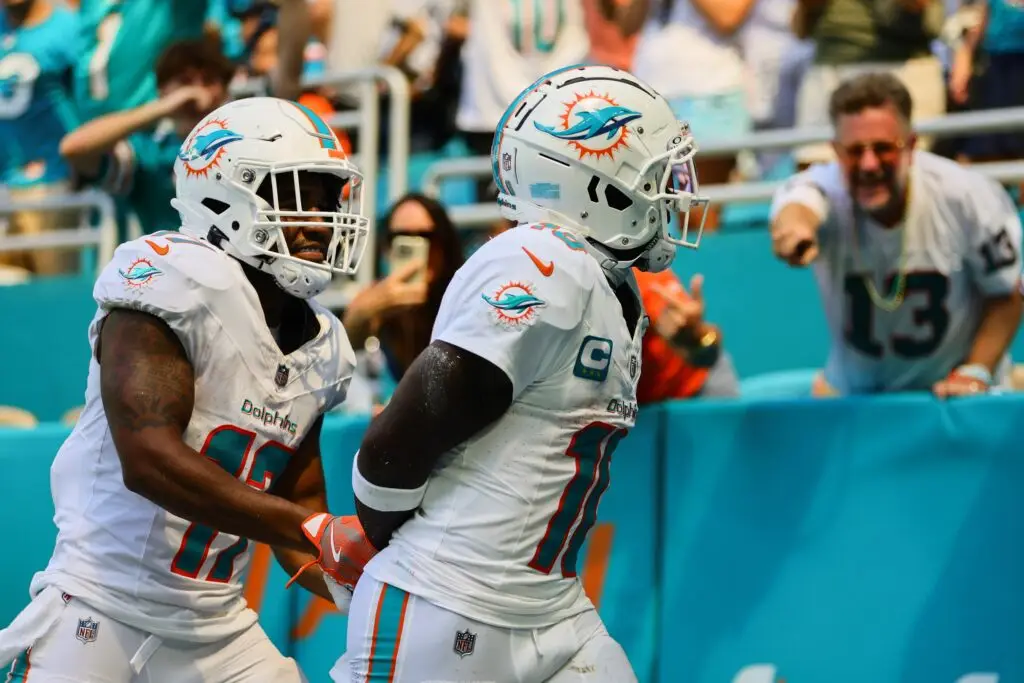 Sep 8, 2024; Miami Gardens, Florida, USA; Miami Dolphins wide receiver Tyreek Hill (10) celebrates with wide receiver Jaylen Waddle (17) after scoring a touchdown against the Jacksonville Jaguars during the third quarter at Hard Rock Stadium. Mandatory Credit: Sam Navarro-Imagn Images