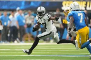 Sep 8, 2024; Inglewood, California, USA; Las Vegas Raiders wide receiver Davante Adams (17) carries the ball against Los Angeles Chargers cornerback <a rel=