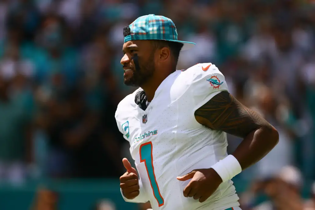 Sep 8, 2024; Miami Gardens, Florida, USA; Miami Dolphins quarterback Tua Tagovailoa (1) runs onto the field before the game against the Jacksonville Jaguars at Hard Rock Stadium. Mandatory Credit: Sam Navarro-Imagn Images