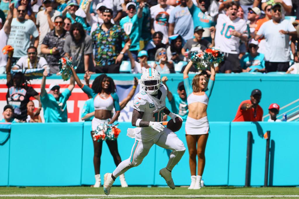 Sep 8, 2024; Miami Gardens, Florida, USA; Miami Dolphins wide receiver Tyreek Hill (10) run with the football for a touchdown against the Jacksonville Jaguars during the third quarter at Hard Rock Stadium. Mandatory Credit: Sam Navarro-Imagn Images