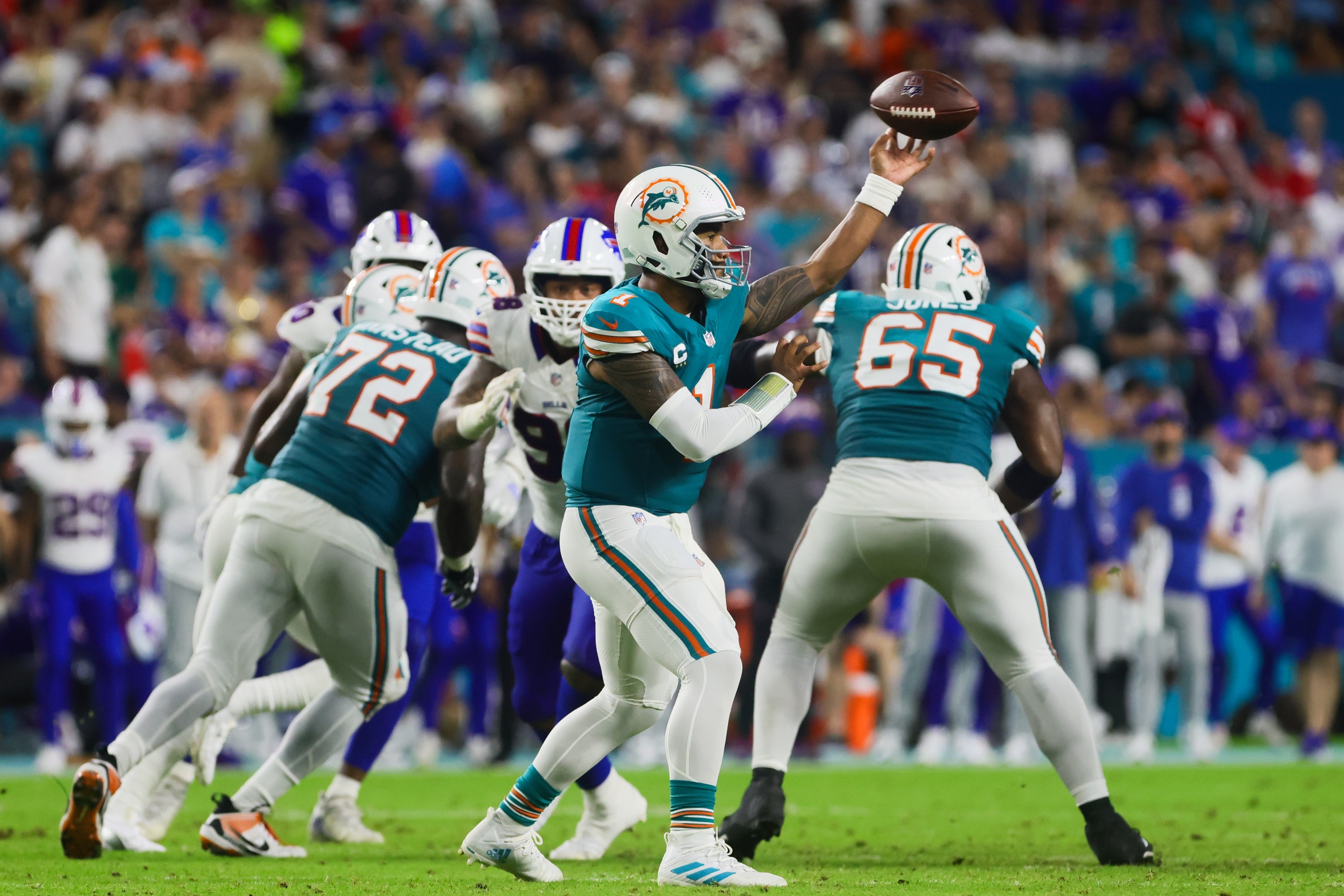 Sep 12, 2024; Miami Gardens, Florida, USA; Miami Dolphins quarterback Tua Tagovailoa (1) throws the football against the Buffalo Bills during the second quarter at Hard Rock Stadium. Mandatory Credit: Sam Navarro-Imagn Images