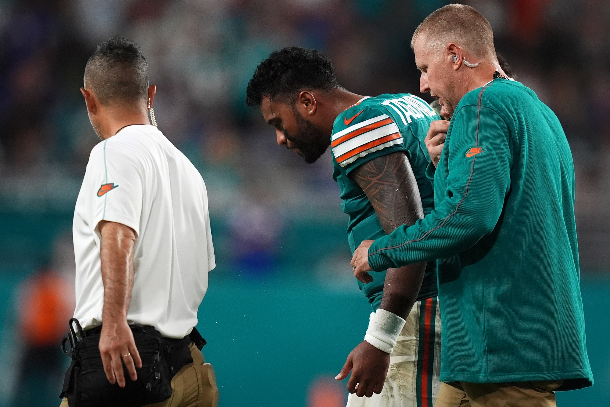 Sep 12, 2024; Miami Gardens, Florida, USA; Miami Dolphins quarterback Tua Tagovailoa (1) walks off the field with training staff after an apparent injury during the second half against the Buffalo Bills at Hard Rock Stadium. Mandatory Credit: Jasen Vinlove-Imagn Images