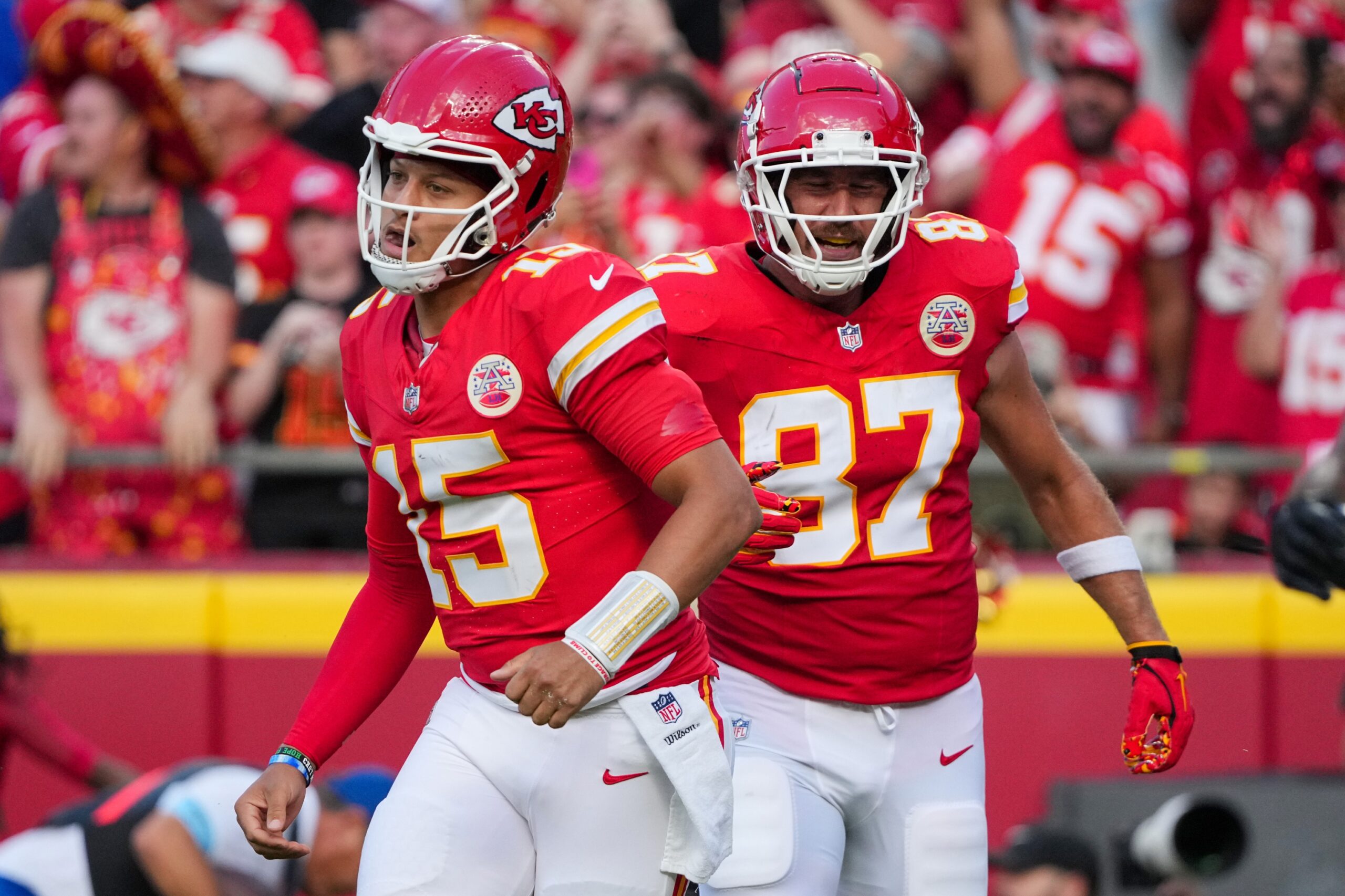 Sep 15, 2024; Kansas City, Missouri, USA; Kansas City Chiefs quarterback Patrick Mahomes (15) and tight end Travis Kelce (87) return to the sidelines after a score against the Cincinnati Bengals during the first half at GEHA Field at Arrowhead Stadium. Mandatory Credit: Denny Medley-Imagn Images