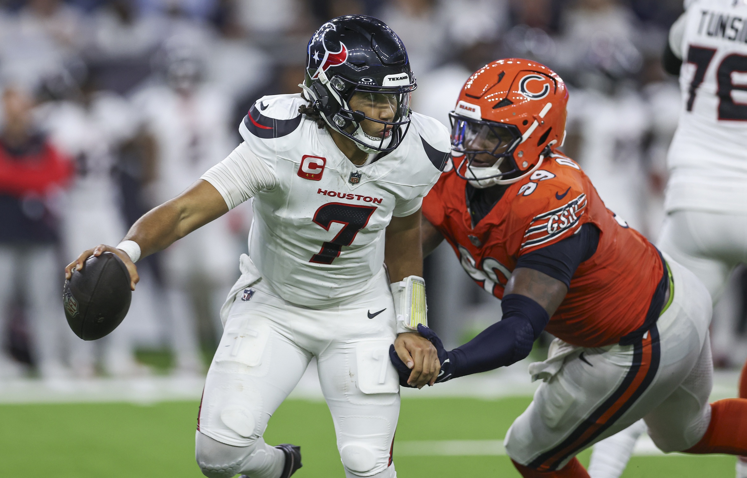 Sep 15, 2024; Houston, Texas, USA; Houston Texans quarterback C.J. Stroud (7) attempts to escape a tackle by Chicago Bears defensive tackle Gervon Dexter Sr. (99) during the fourth quarter at NRG Stadium. Mandatory Credit: Troy Taormina-Imagn Images