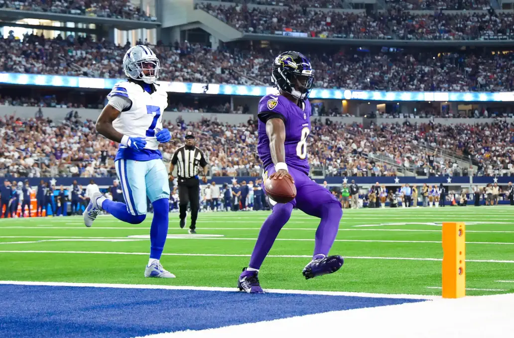 Sep 22, 2024; Arlington, Texas, USA; Baltimore Ravens quarterback Lamar Jackson (8) runs past Dallas Cowboys cornerback Trevon Diggs (7) and scores a touchdown during the first quarter at AT&T Stadium. Mandatory Credit: Kevin Jairaj-Imagn Images