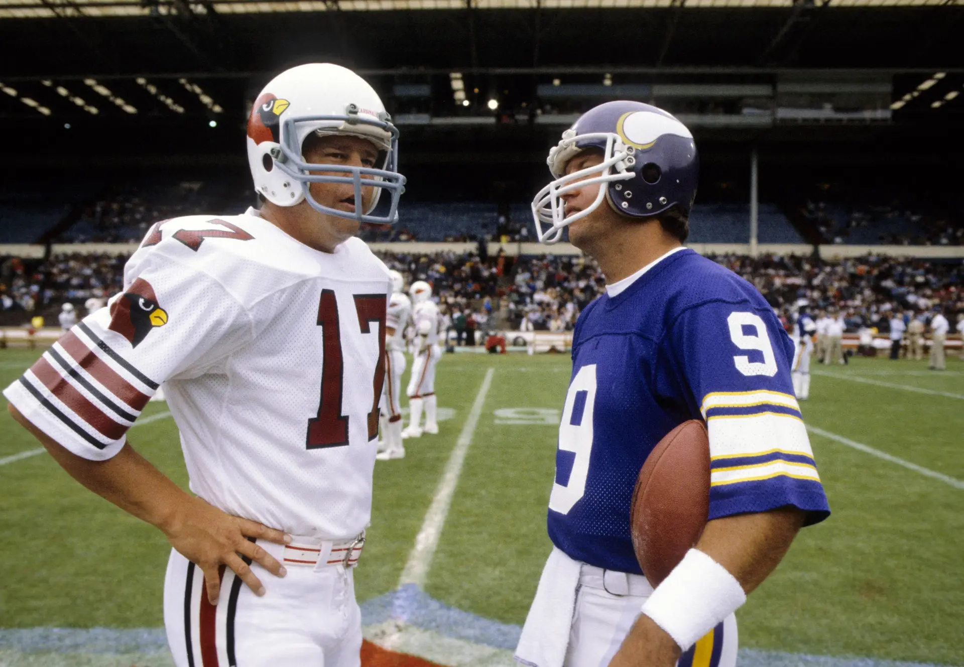 Aug 6, 1983; London, ENGLAND; FILE PHOTO; St. Louis Cardinals quarterback Jim Hart (17) talks with Minnesota Vikings quarterback Tommy Kramer (9) prior to the inaugural NFL International Series game at Wembley Stadium. Mandatory Credit: Herb Weitman-Imagn Images