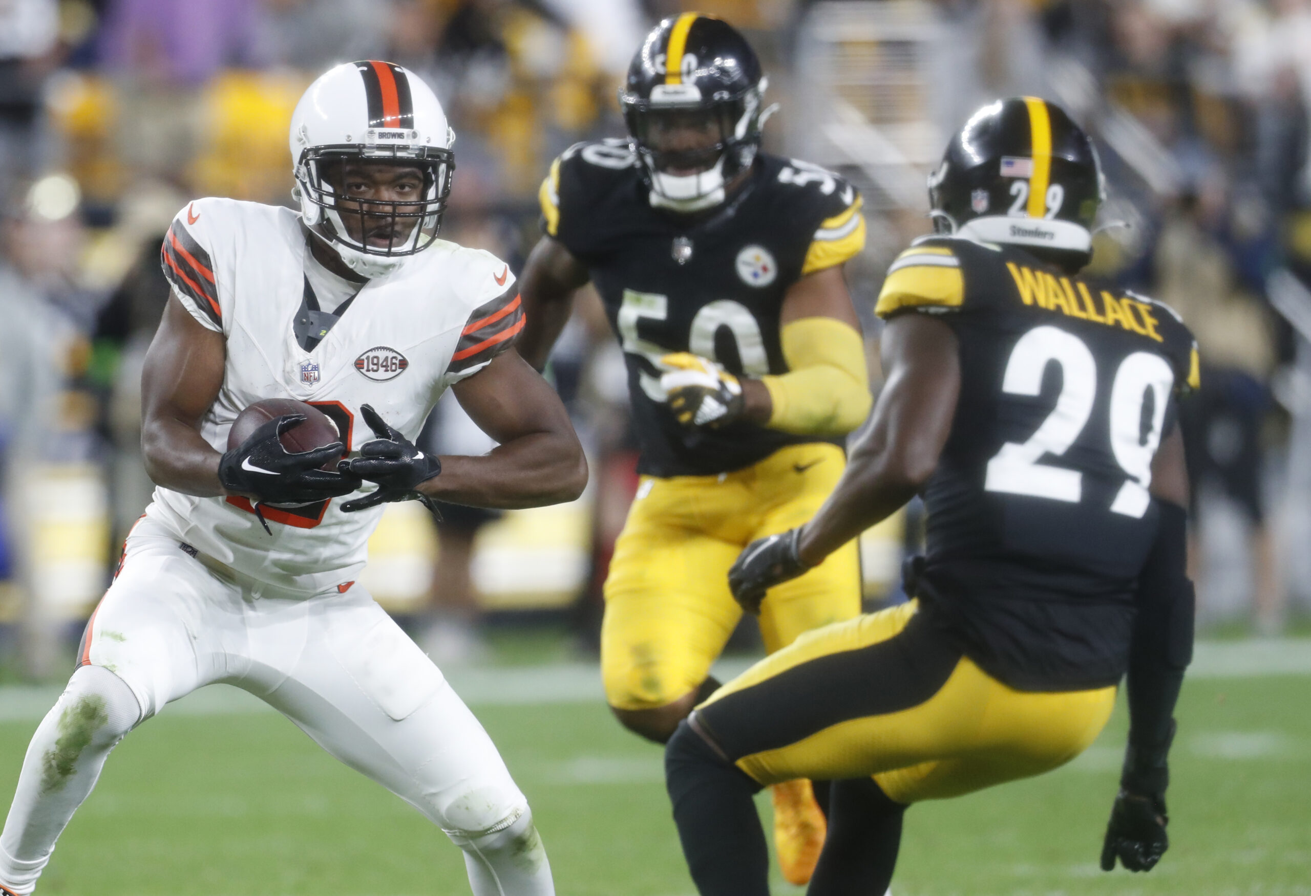 Sep 18, 2023; Pittsburgh, Pennsylvania, USA; Cleveland Browns wide receiver Amari Cooper (2) runs after a catch as Pittsburgh Steelers linebacker Elandon Roberts (50) and cornerback Levi Wallace (29) defend during the fourth quarter at Acrisure Stadium. Pittsburgh won 26-22. Mandatory Credit: Charles LeClaire-Imagn Images