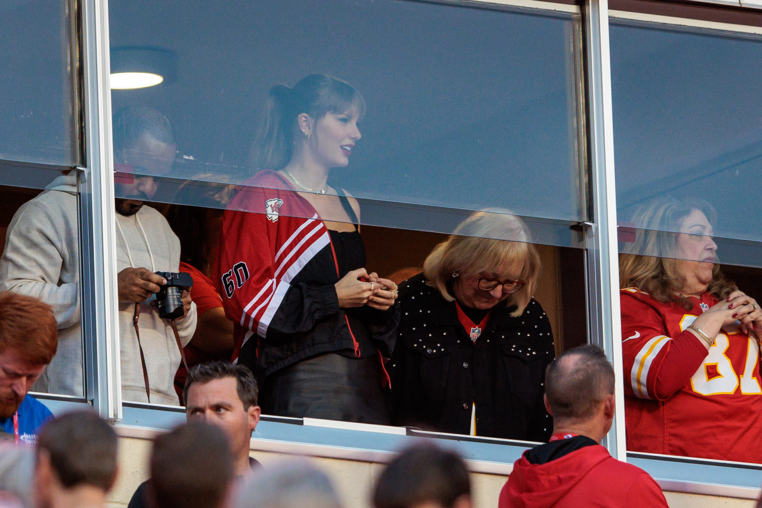 Oct 12, 2023; Kansas City, Missouri, USA; Grammy award winning artist Taylor Swift watches Kansas City Chiefs take the field along with Kansas City Chiefs tight end Travis Kelce (87) mom Donna Kelce prior to the game against the Denver Broncos at GEHA Field at Arrowhead Stadium. Mandatory Credit: William Purnell-Imagn Images